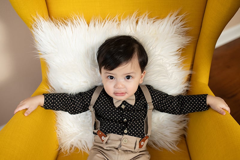 Boy seated in a large chair