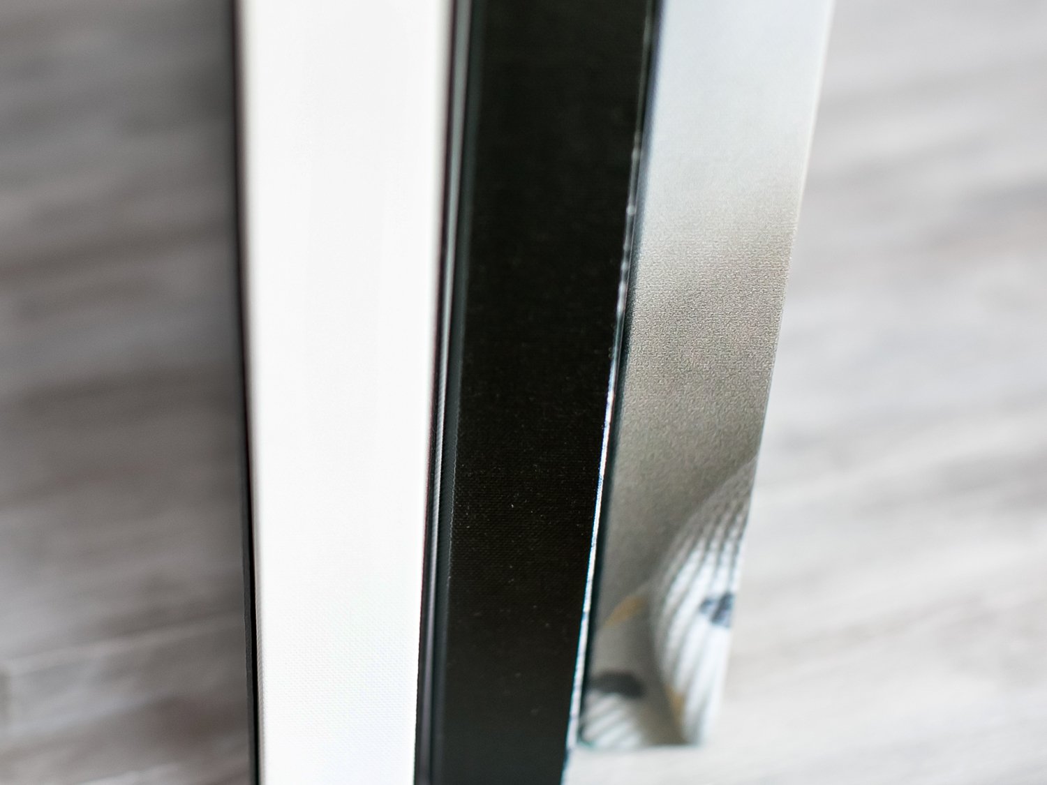 Three gallery wrapped canvases showing the border options - solid white, solid black, and image wrapped