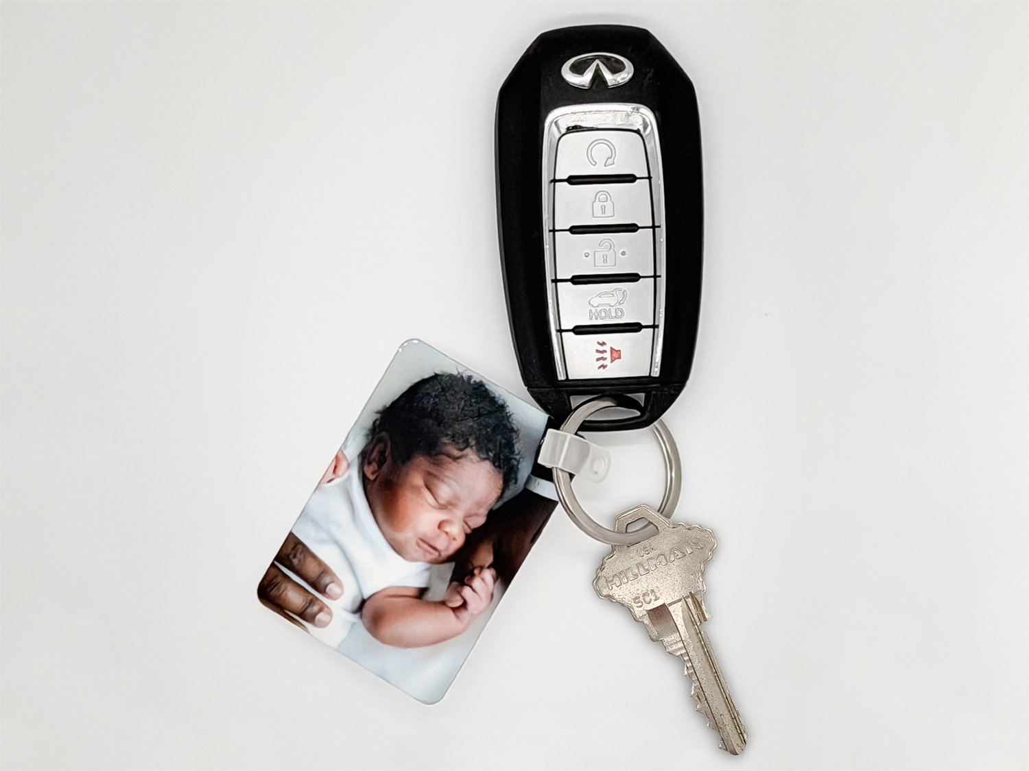 Rectangular photo keychain on a key ring with house and car keys
