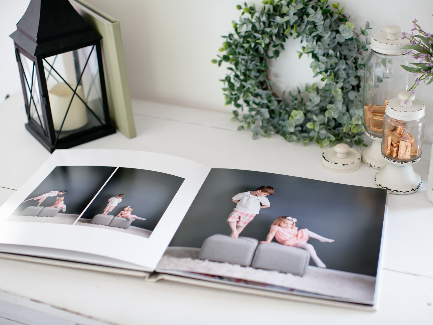 Open photo album showing interior pages and the album’s bottom edge.