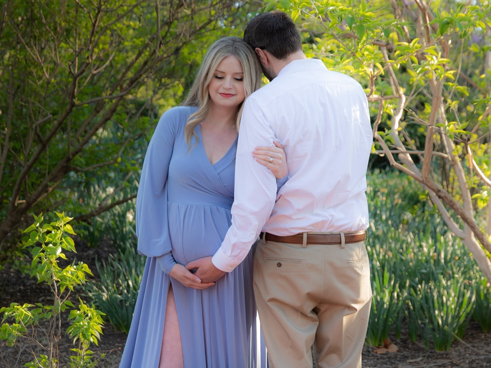 Husband and wife posing for a maternity photoshoot