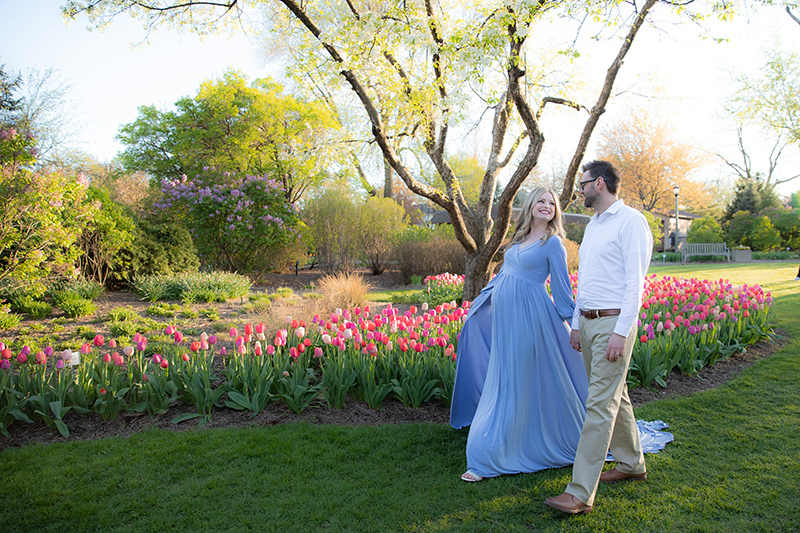 Example of outfits styled to complement an outdoor park setting, featuring a man in a relaxed, polished look and a woman in a flowy dress.