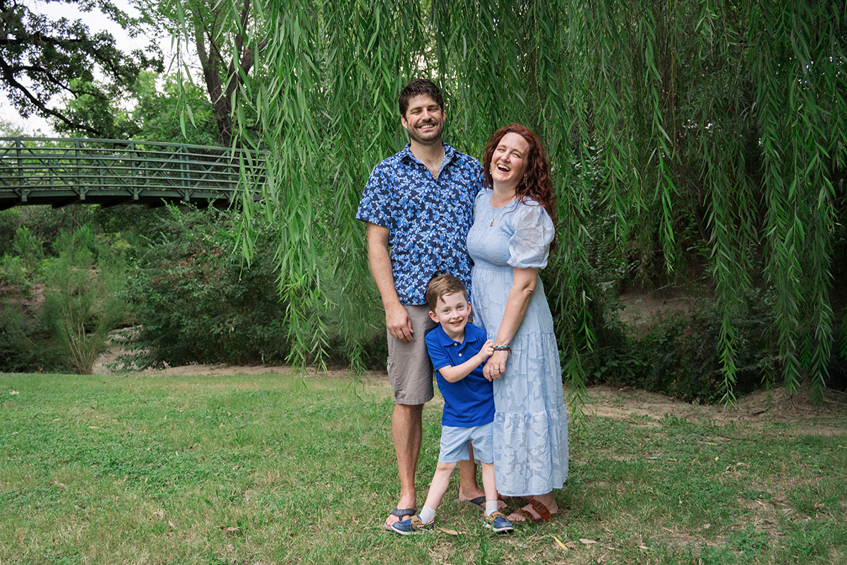 Parents and son styled in varying blue tones and subtle patterns for a coordinated, non-matching look.