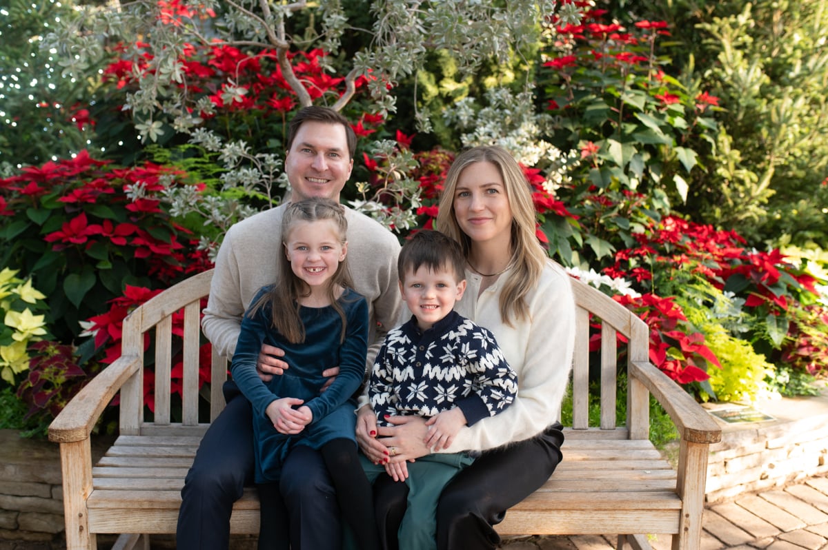 Smiling family seated on a bench at Garfield Park Conservatory